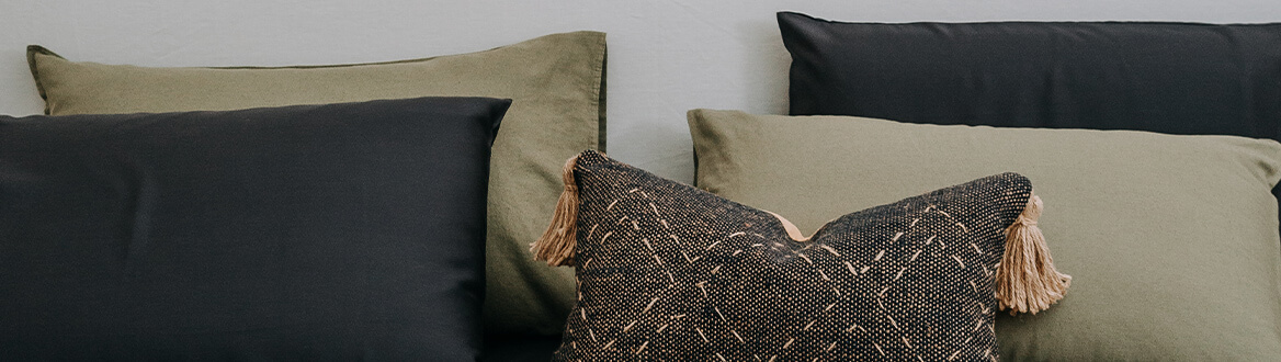 black and khaki pillows on bed