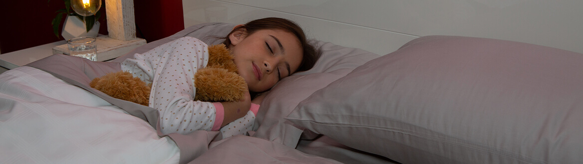 Young girl asleep with teddy
